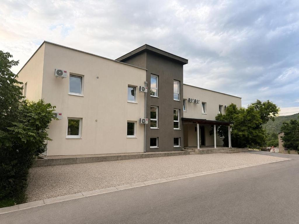 a large white building on the side of a road at Guest House Kekusic in Međugorje