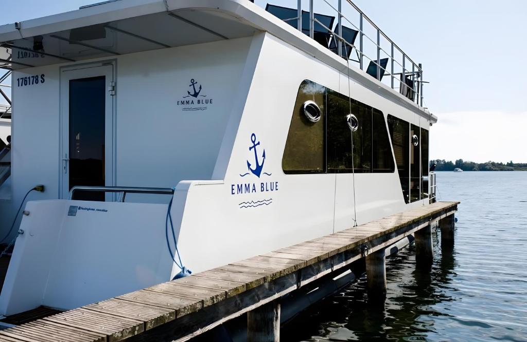 a ferry boat is docked at a dock at Hausboot Emma Blue in Röbel