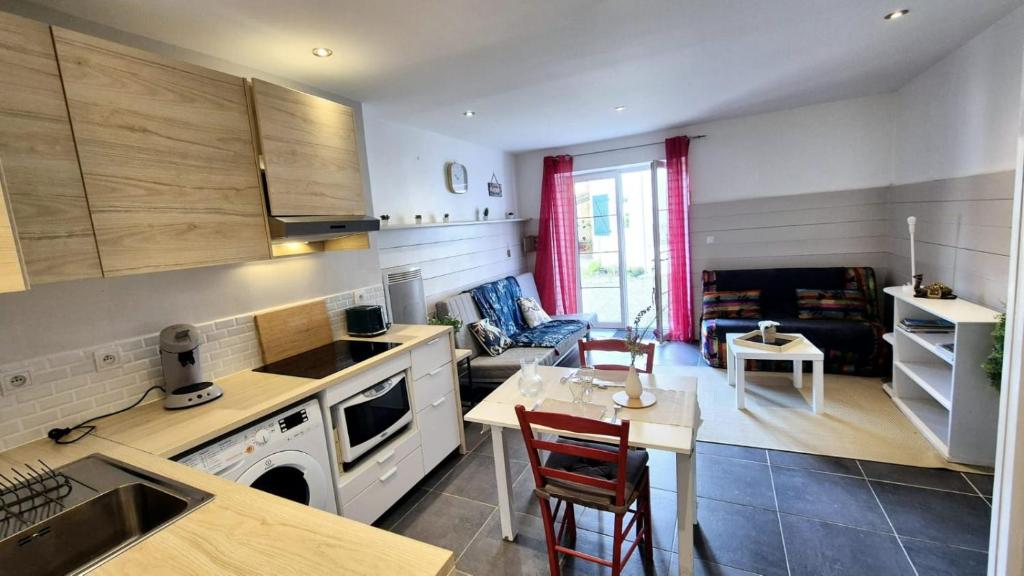 a kitchen and living room with a table and chairs at Garaztegia Studio in Ustaritz