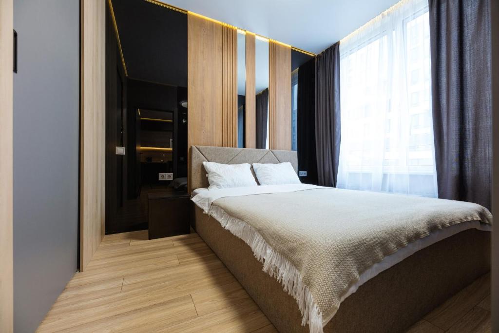 a bedroom with a large bed and a large window at Fayna Town Comfort #2 in Kyiv