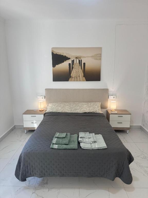 a bedroom with a bed with two towels on it at A vacation by the sea in Puerto de Sagunto