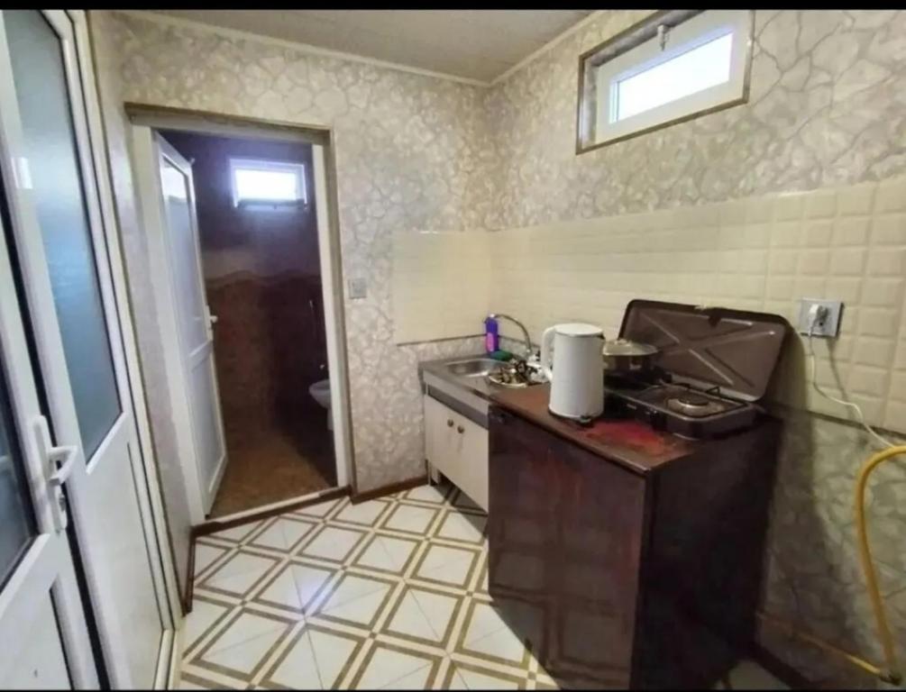 a small bathroom with a sink and a shower at good house in Quba