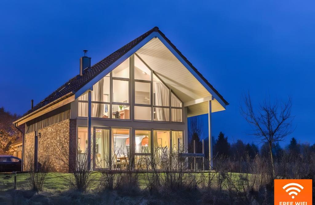 a house with large glass windows on the side of it at Haus W 7 in Röbel