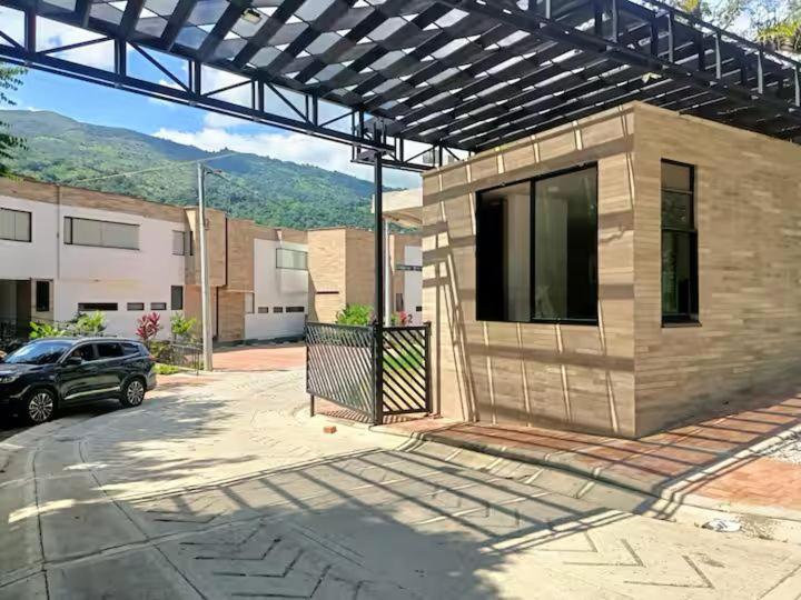 a building with a car parked in a parking lot at Miramonte Payande in Nimaima