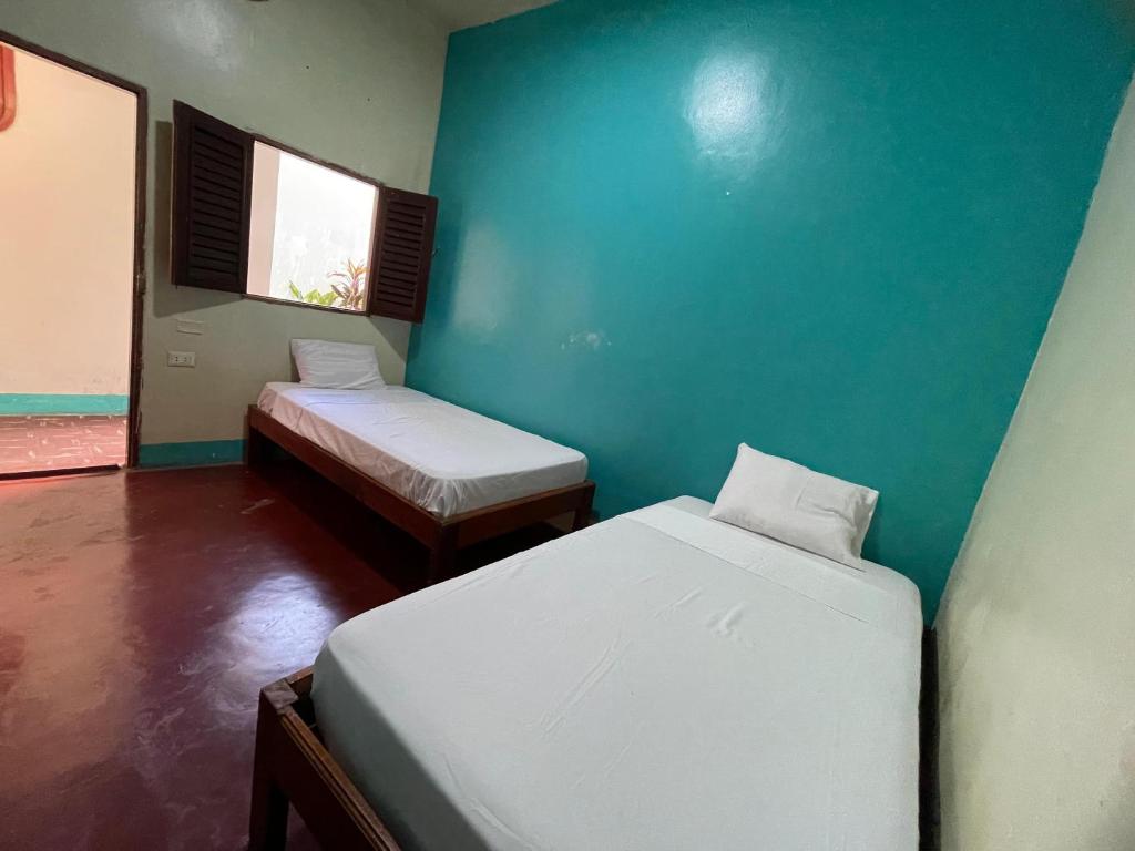 A bed or beds in a room at The Grindio Hostel