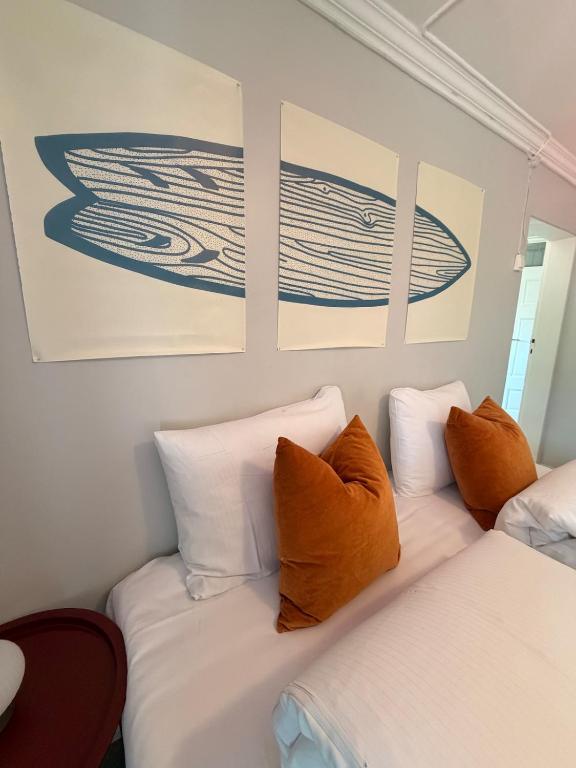 a room with two beds and paintings on the wall at Lofoten Town Villa I Sleeps 9 in Leknes