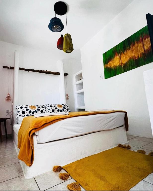 a bedroom with a bed and two lamps and a rug at 7olives Golden Boutique Apartment in Kastraki