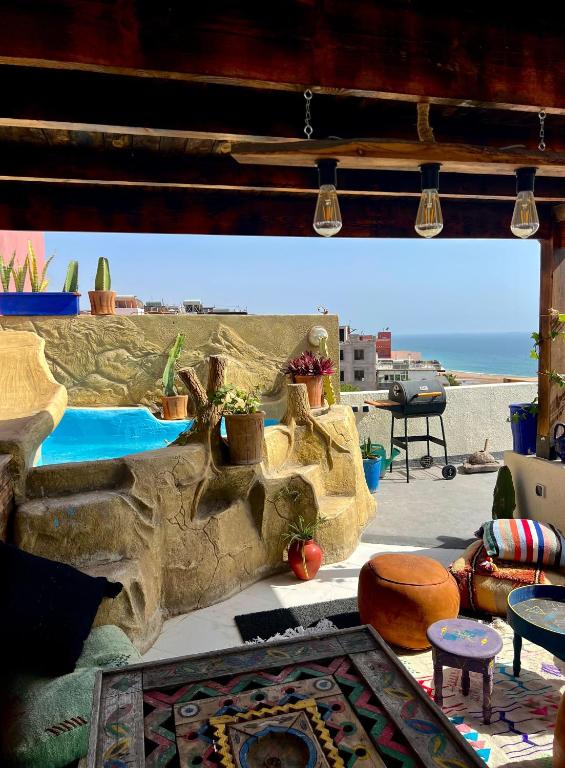 a living room with a view of the ocean at Ocean Breeze Guest House in Tamraght Ouzdar
