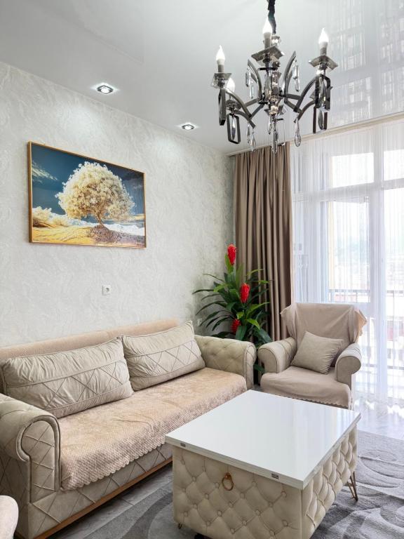 a living room with a couch and a table at DS & Sea Suites Batumi in Batumi