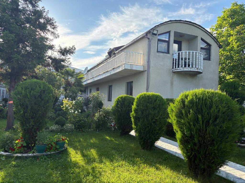 a house with a balcony and some bushes at Alazani 2015 in Duisi