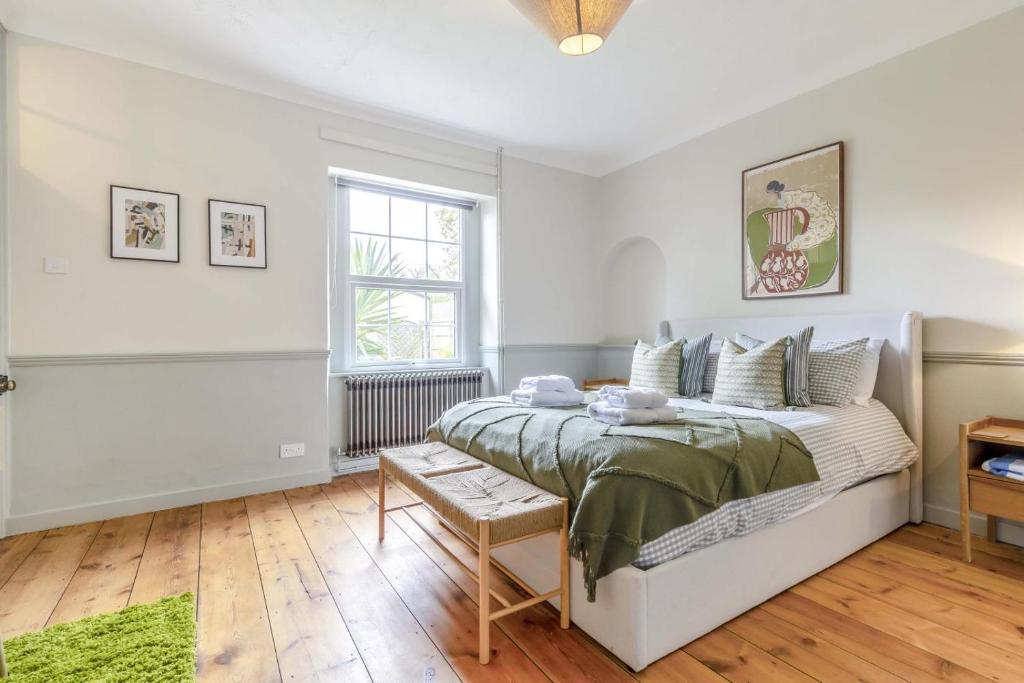 a white bedroom with a bed and a window at 3 Bed in Northrepps oc-k29801 in Cromer