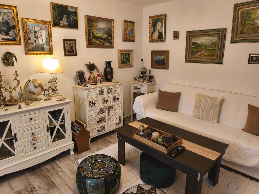 a living room with a couch and a table at Casa Luna in Călimăneşti