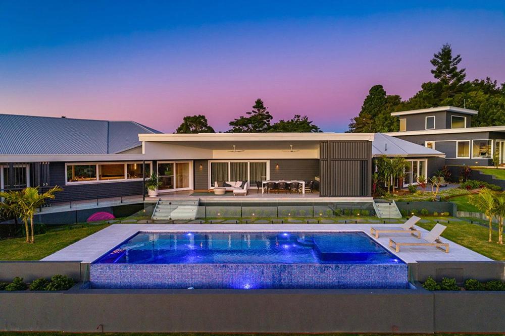 a house with a swimming pool in front of it at Byron Retreat in Coopers Shoot