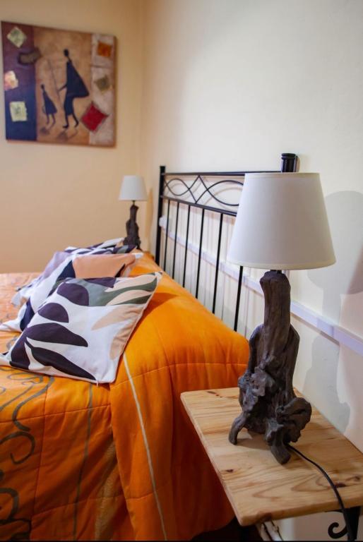 a lamp on a table next to a bed at Posada de Labaien in Beinza-Labayen
