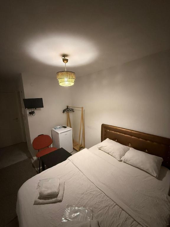 a bedroom with a bed and a lamp and a chair at Şişli Suites - Room48 in Istanbul