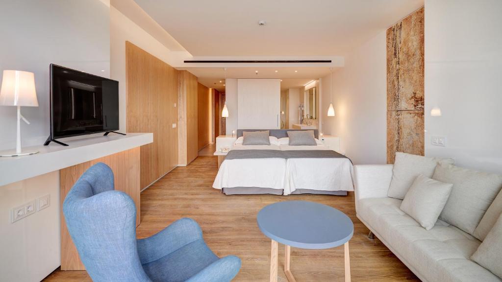 a living room with a couch and a bed at Hipotels Playa de Palma Palace&Spa in Playa de Palma