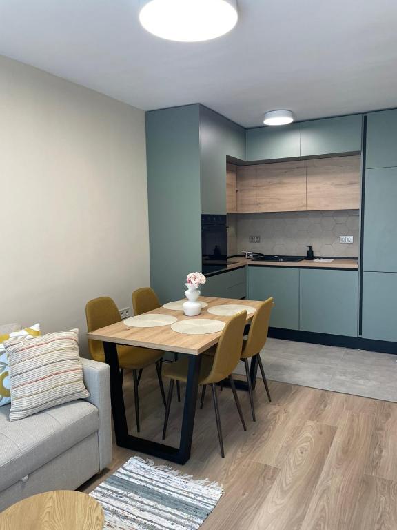 a kitchen and dining room with a table and a couch at Medoni Summer Hive in Sozopol