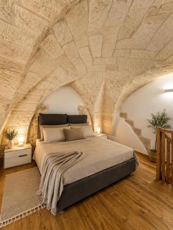 a bedroom with a bed with a stone ceiling at Piazza San Giorgio B&B in Serrano