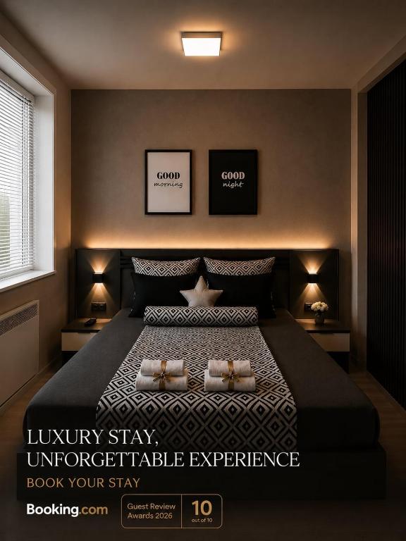 a bedroom with a large bed with two pillows on it at NOA Luxury Apartment in Bitola