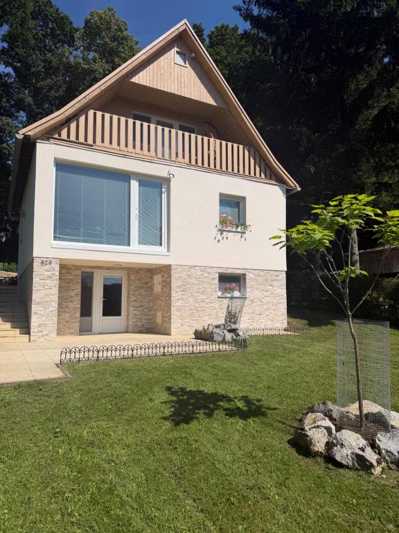 a house with a tree in the yard at Chata pod loukou in Tvarožná Lhota