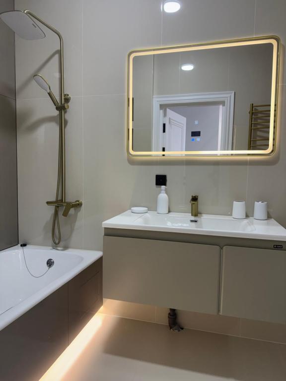 a white bathroom with a sink and a mirror at NRG BI Sado in Salor Bekati