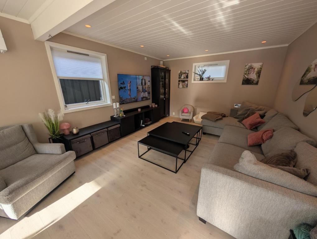 a living room with a couch and a table at hus in Moss