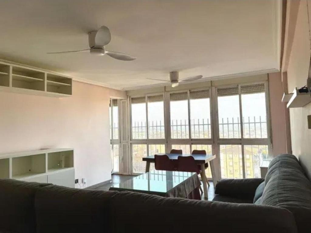 a living room with a couch and a glass table at Alma Andaluza Apart 1 in Mairena del Aljarafe