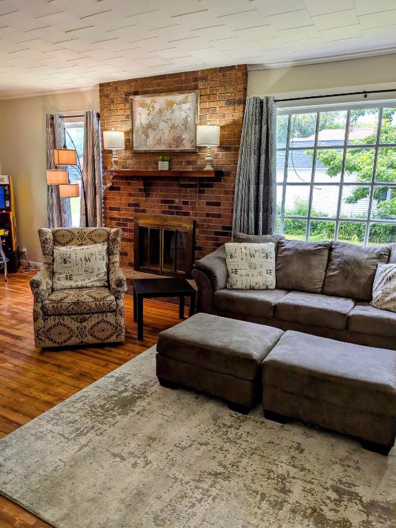 a living room with a couch and a fireplace at Hook Wine and Sinker in Marion