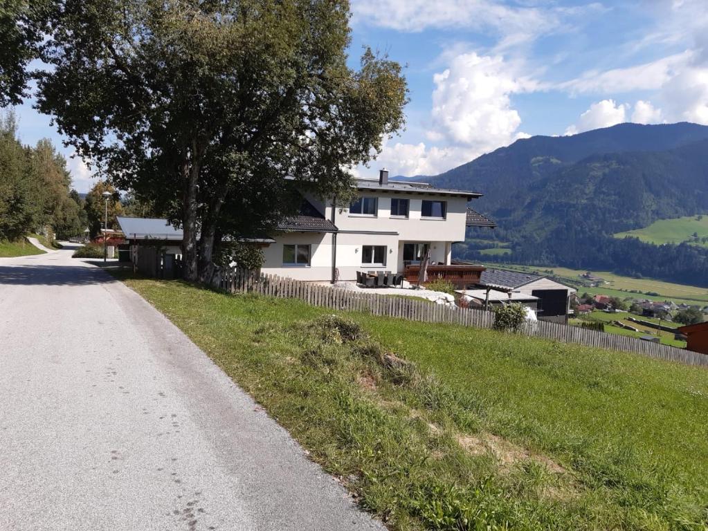 a white house on the side of a road at Haus Anneliese in Gröbming