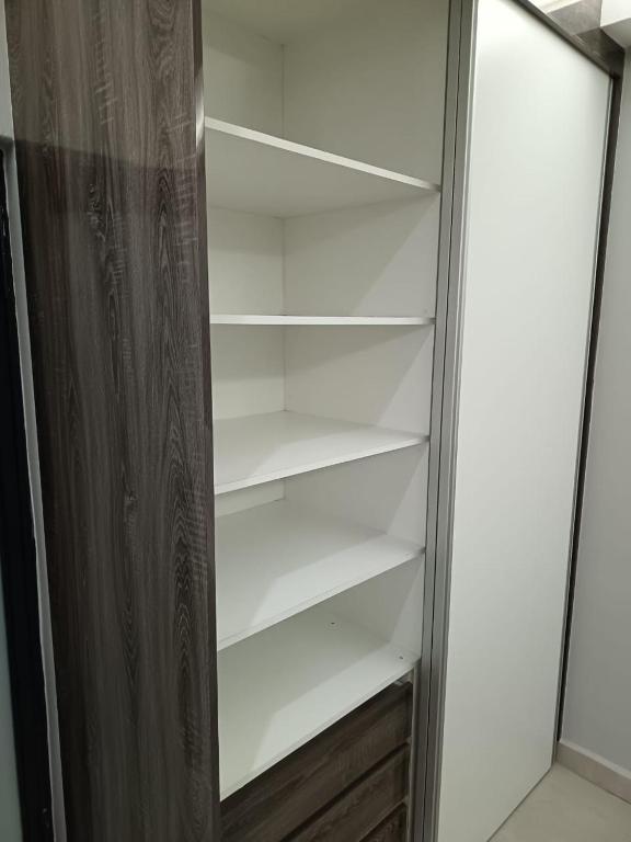 a refrigerator with empty shelves in a room at New Hillcrest centre guest House in Kimberley