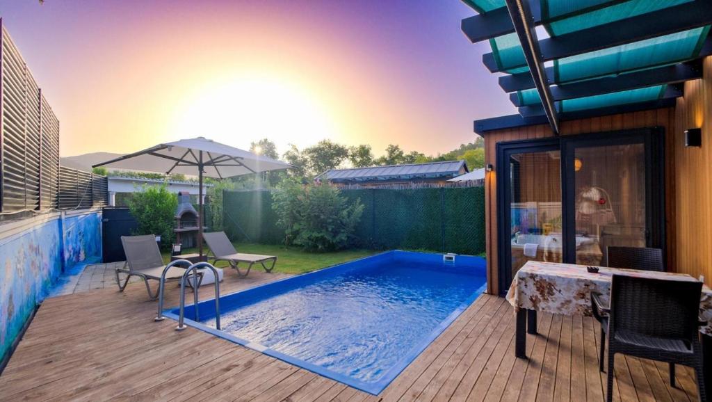 a swimming pool on a deck with a house at Egem Tatil Evleri in Fethiye