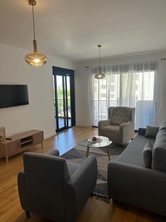 a living room with a couch and chairs and a tv at Apartment 22 - calm location in Bar