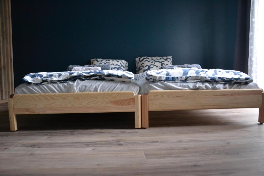 a bed with a wooden frame in a room at Hotel Mergera in Mērsrags