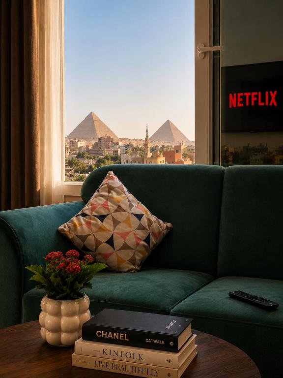 a living room with a couch and a table with books at La Veranda Pyramids View Hotel in Cairo