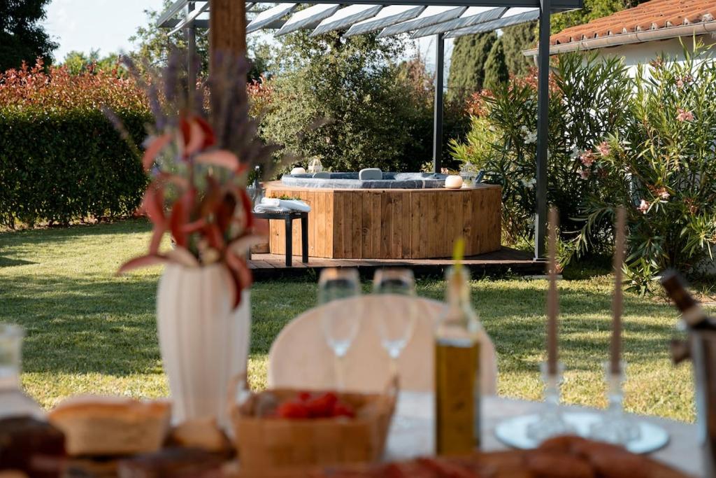 a table with a bowl of fruit and a table with a hot tub at Casa Le Camelie idromassaggio e relax Lucca in Capannori