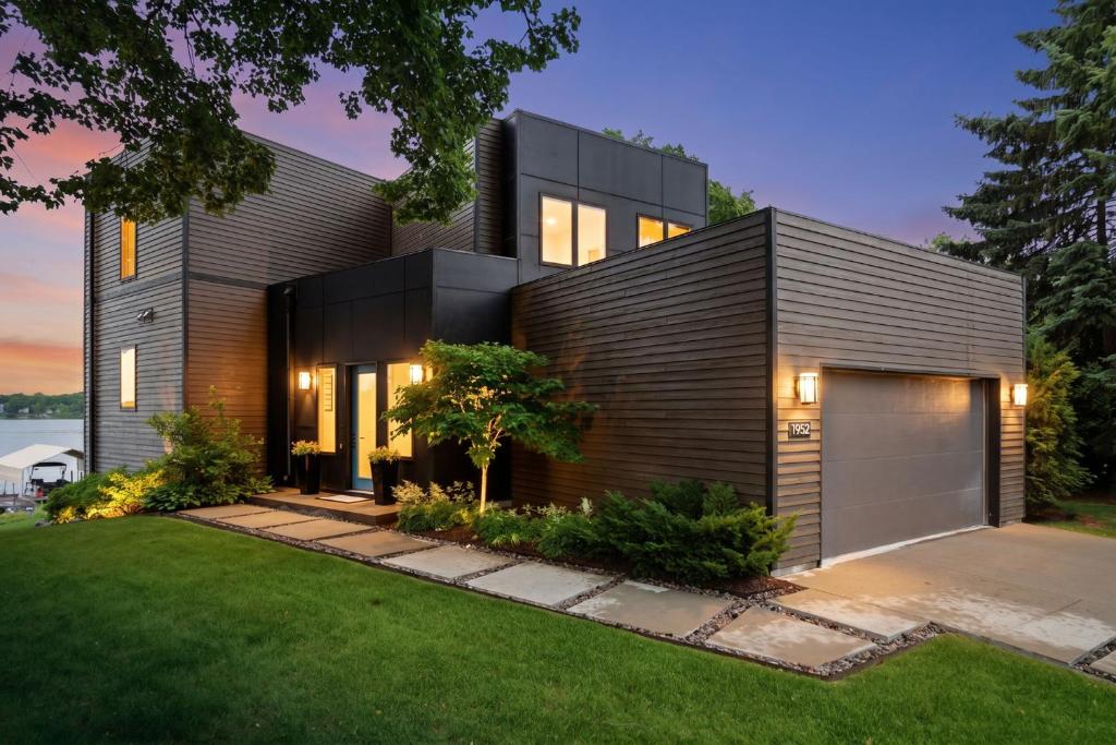 a modern home with a black house at Lakefront Luxury in Mound