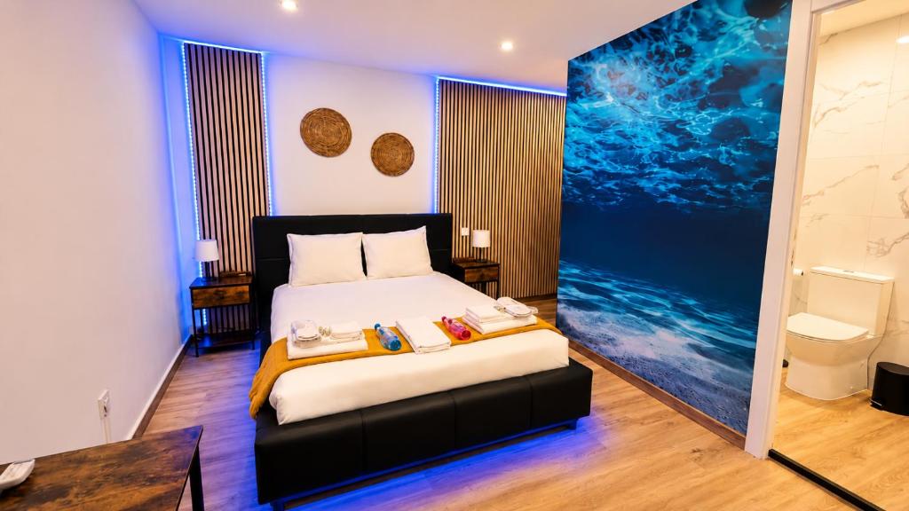 a bedroom with a bed and a painting on the wall at 77 Lisbon Design Apartment near Airport, Lisbon, Amadora, Odivelas & Sintra in Caneças