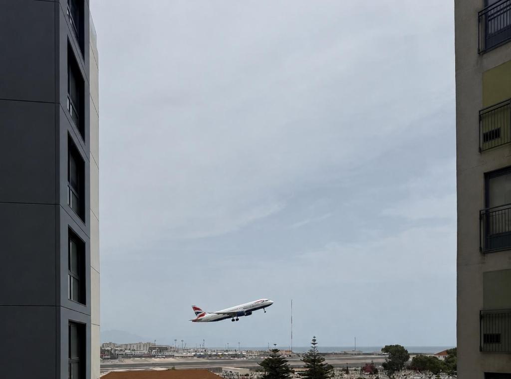 an airplane is taking off from an airport at New CP Victory suites studio sleeps 4 with pool and gym in Gibraltar