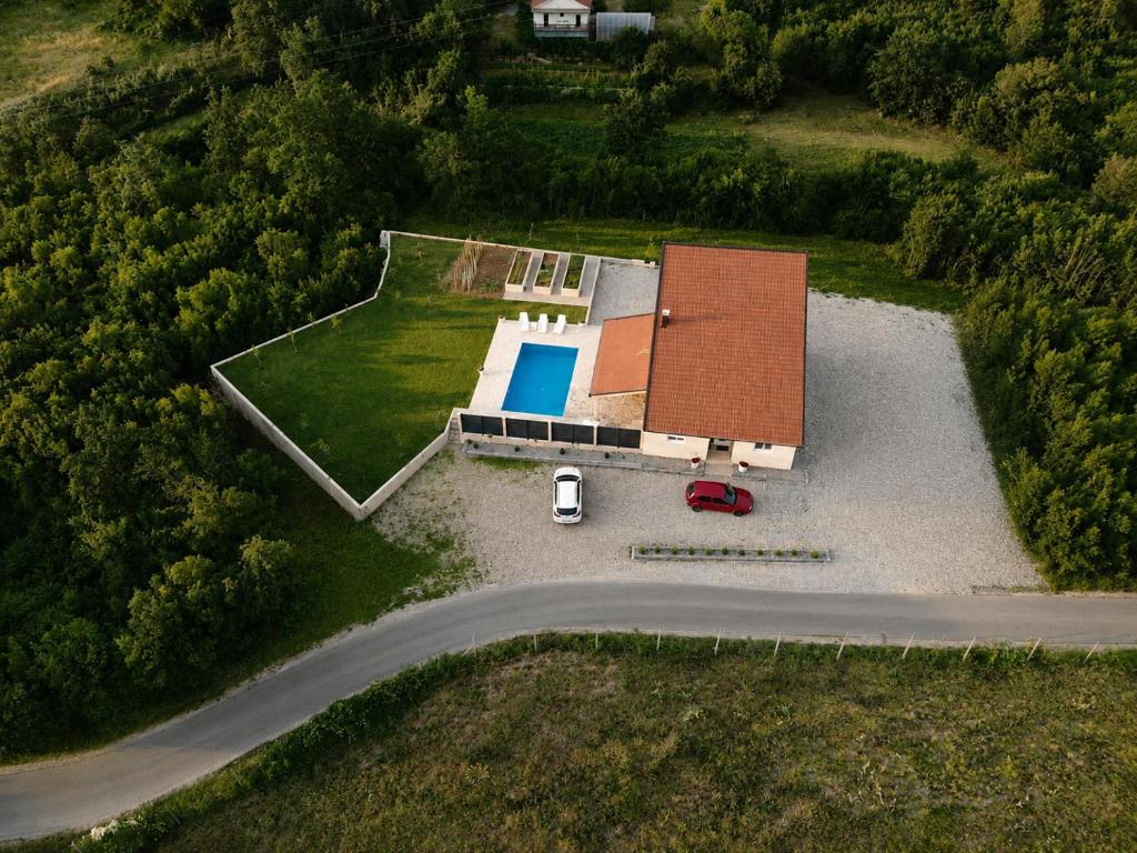 an overhead view of a house with a swimming pool at Stan na dan BOVKA in Široki Brijeg