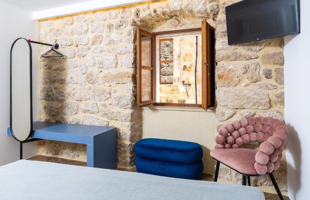 a room with a table and two chairs and a window at Villa Four Winds II in Dubrovnik