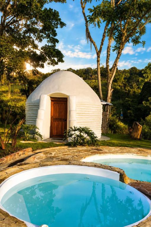 a dome house with two pools in front of it at Aldea Ancestral by ID Hotel in Barbosa
