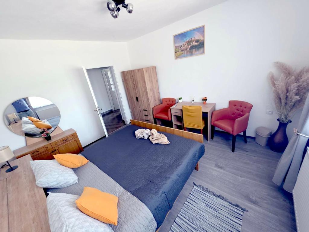 a bedroom with a bed and a table and chairs at Peđa in Ogulin
