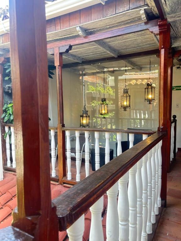 a porch of a house with a white railing at Hotel Galeria la Trinidad in Cartagena de Indias