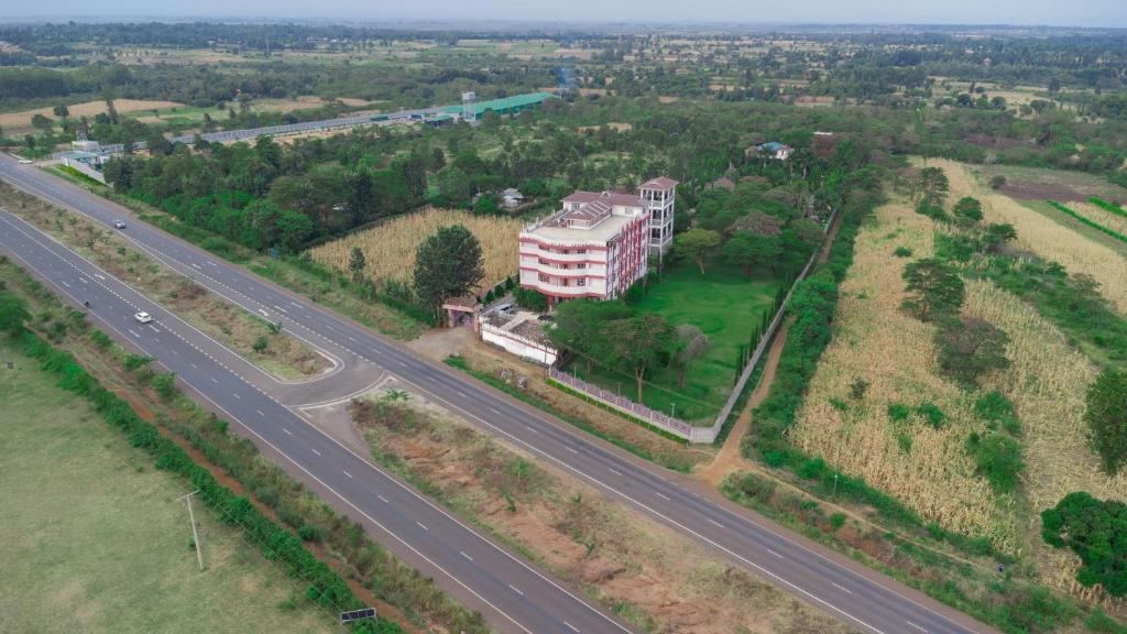 an aerial view of a building next to a highway at Destination Resort Centre in Gikuu