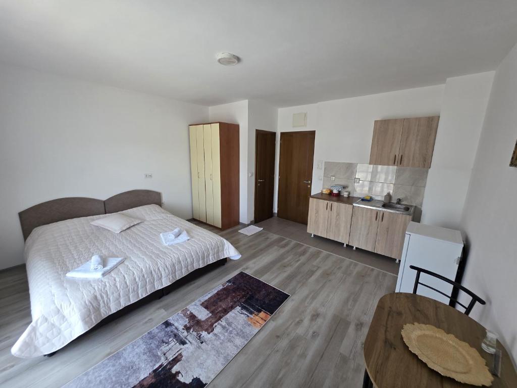 a bedroom with a bed and a table in it at NP Luxury Apartments in Novi Pazar