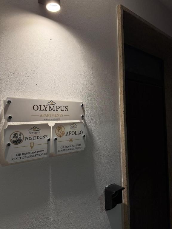 a sign on a wall next to a door at Tropea Olympus Apartments in Santa Domenica