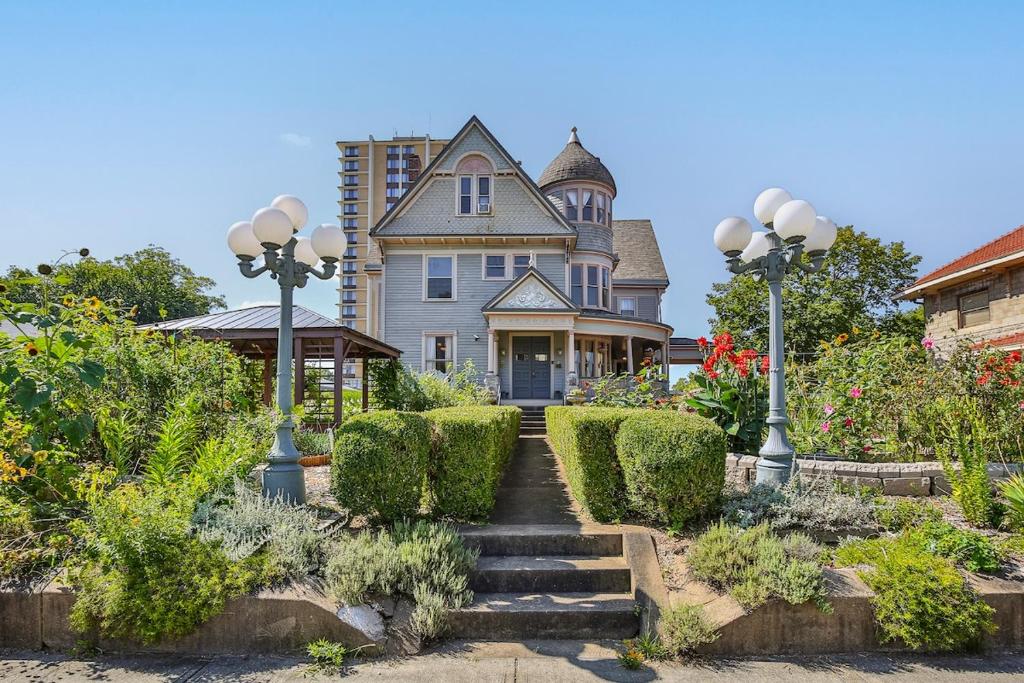 a house with a staircase in front of it at 1895 Victorian Home on Historic Walnut Street in Springfield