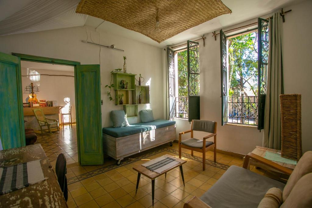a living room with a couch and some windows at Precioso departamento privado in Morelia