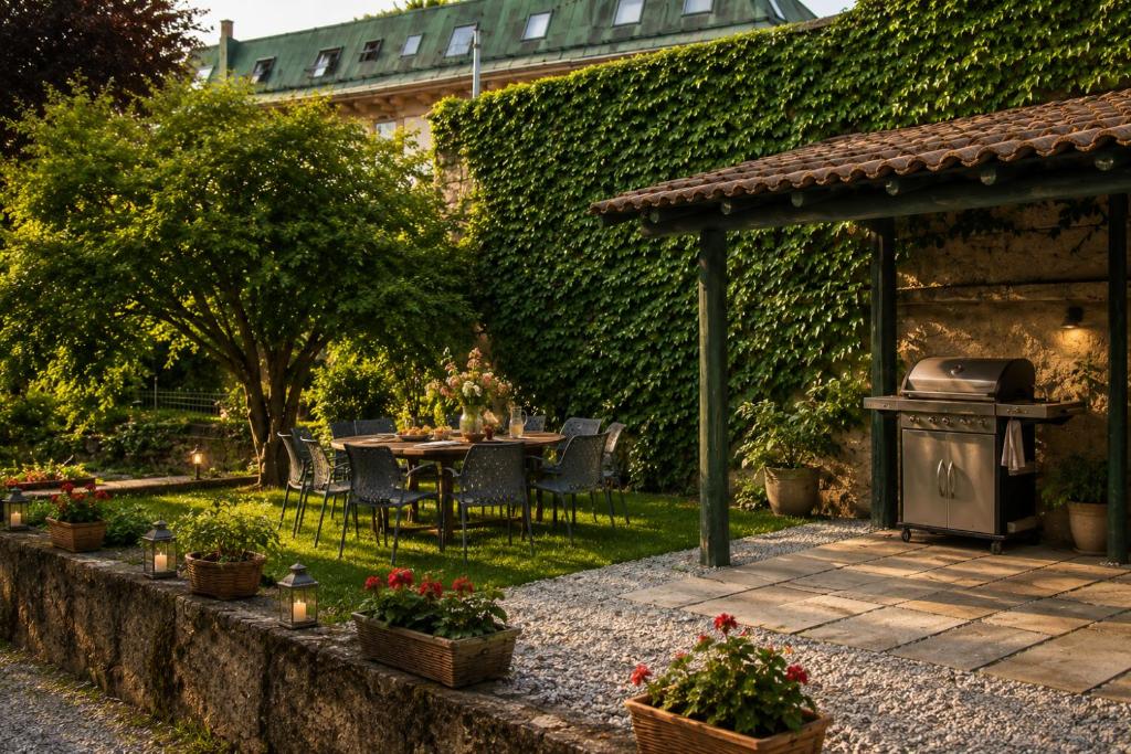 a garden with a table and chairs and a grill at Iris Peaceful Apartment near Lake Como and Lugano in Lanzo dʼIntelvi