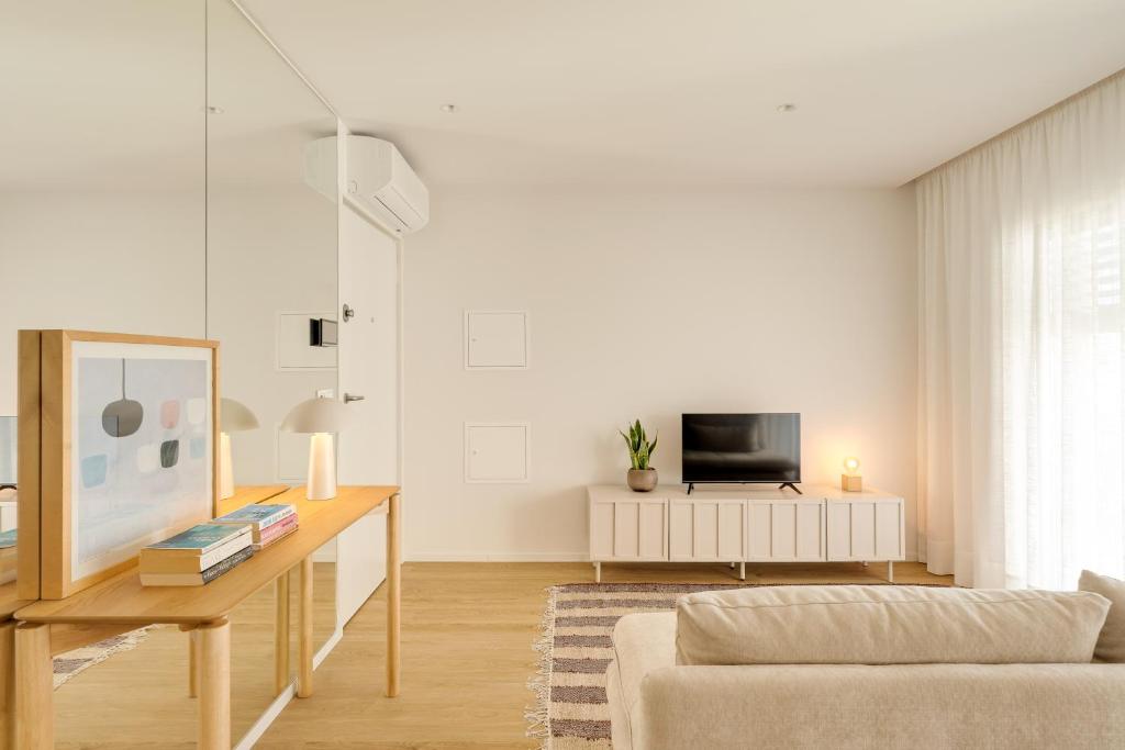 a living room with a couch and a table at Matosinhos in Matosinhos